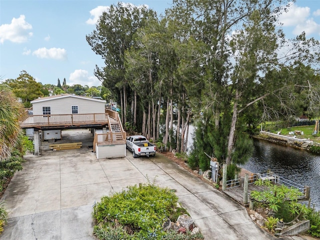14904 Old Dixie Hwy, Hudson, FL 34667 - view of front of home featuring a deck with water view and concrete driveway