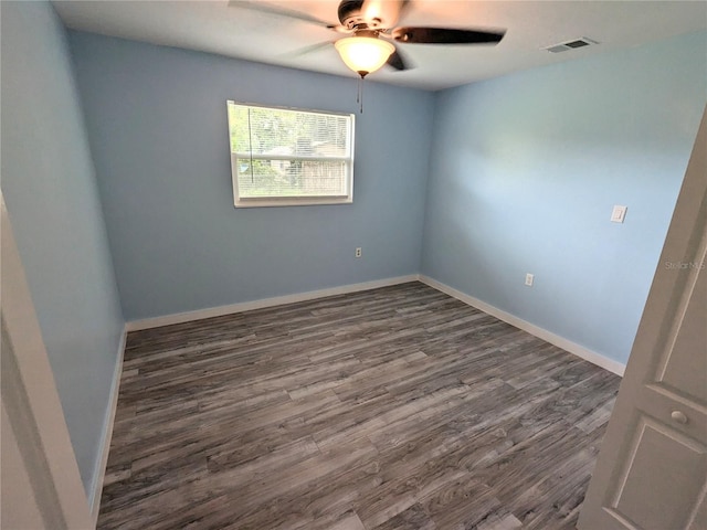 empty room with ceiling fan and dark hardwood / wood-style floors