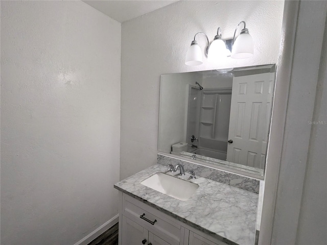 full bathroom with shower / tub combination, vanity, and toilet