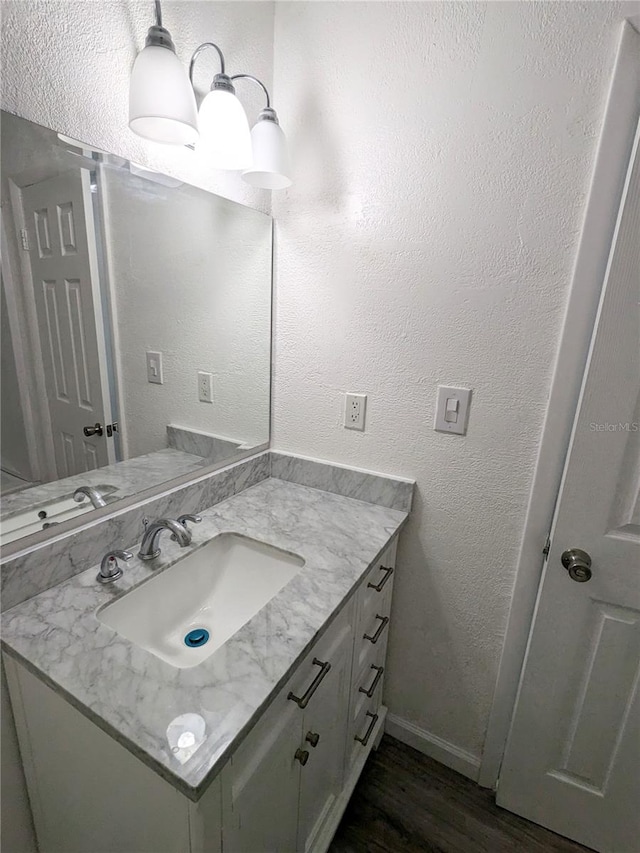 bathroom featuring hardwood / wood-style flooring and vanity