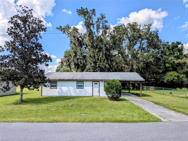 ranch-style home with a front yard and a carport