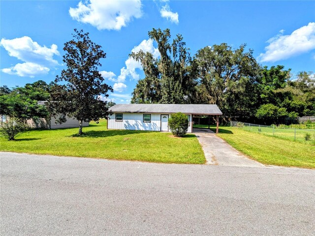 ranch-style house with a front yard and a carport