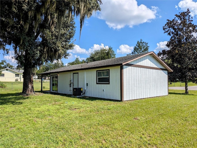 exterior space featuring central air condition unit and a yard