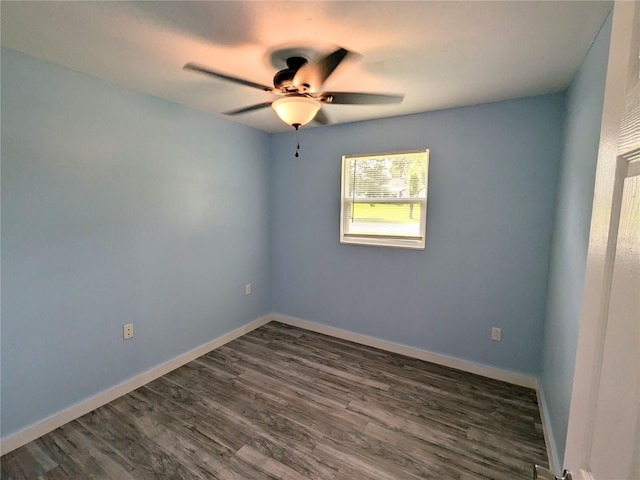 empty room featuring ceiling fan and dark hardwood / wood-style flooring