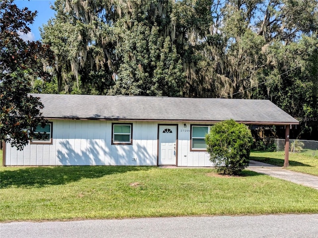 ranch-style home with a front lawn