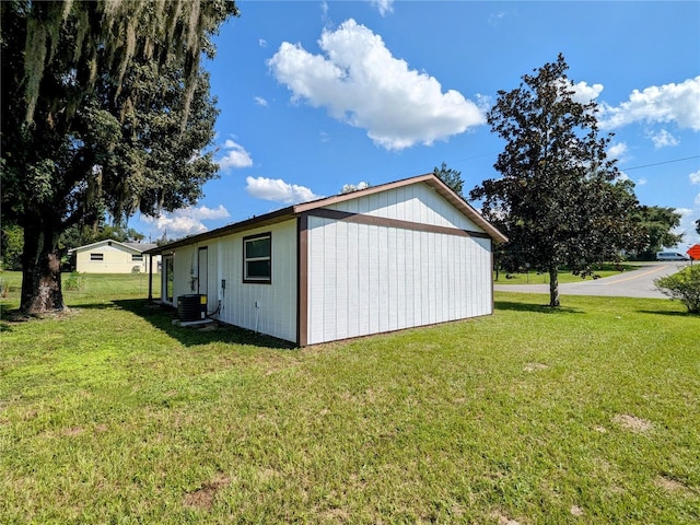 view of home's exterior with central AC unit and a lawn