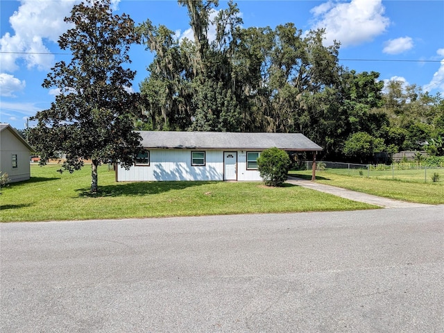 ranch-style home featuring a front yard and a carport