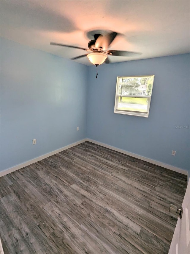 unfurnished room with ceiling fan and dark hardwood / wood-style flooring