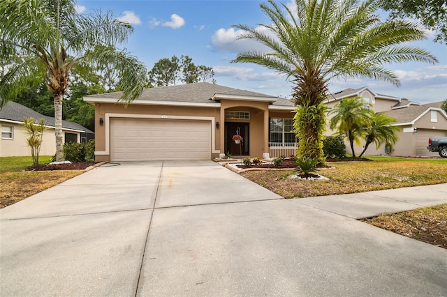 ranch-style house featuring stucco siding, a front lawn, concrete driveway, and an attached garage