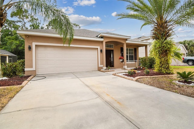 view of front of house with stucco siding, driveway, and an attached garage