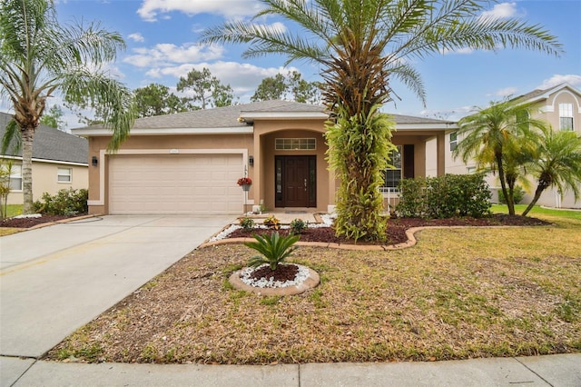 single story home with stucco siding, a front yard, concrete driveway, and an attached garage