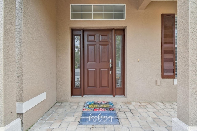 doorway to property with stucco siding