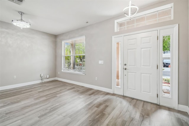 entrance foyer featuring wood finished floors and baseboards