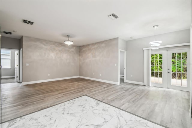 empty room with visible vents and a healthy amount of sunlight