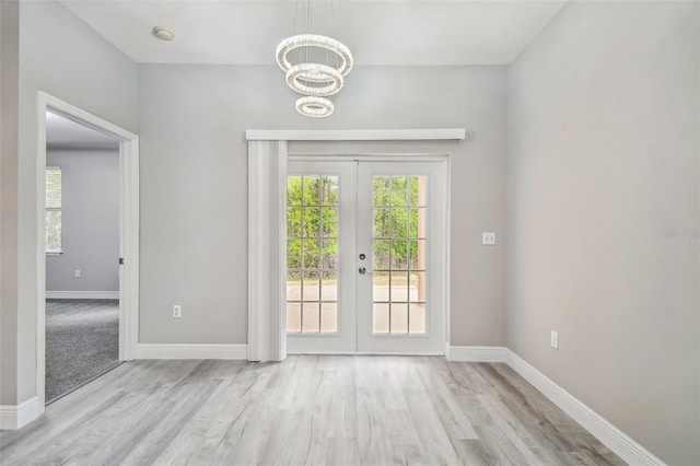 entryway with french doors, light wood-type flooring, and baseboards