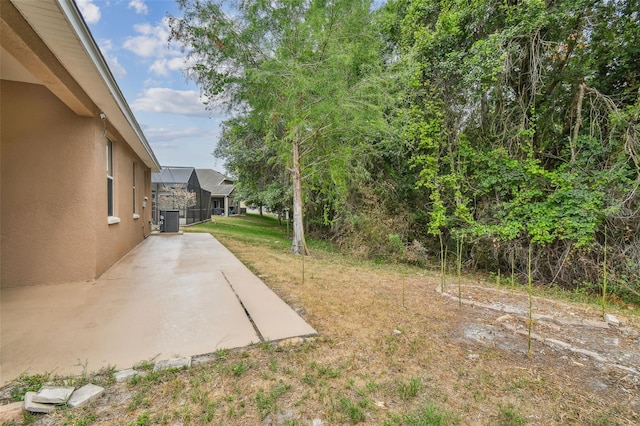 view of yard featuring central air condition unit and a patio area