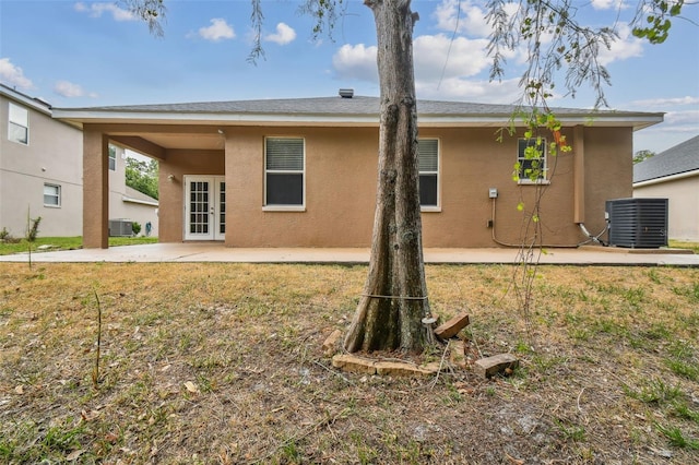 back of house with stucco siding, cooling unit, and a patio