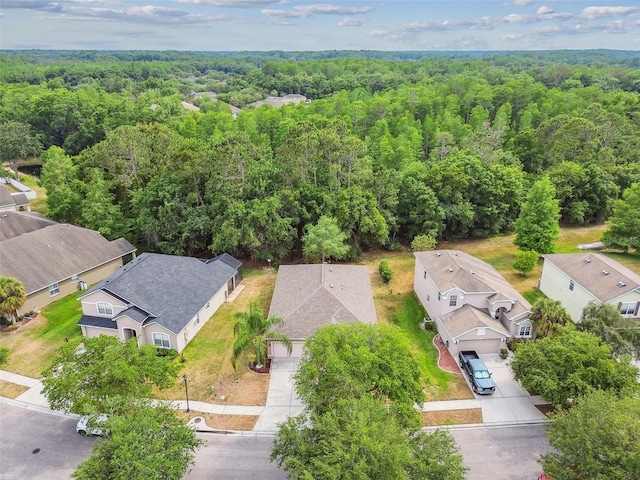 birds eye view of property featuring a residential view and a forest view