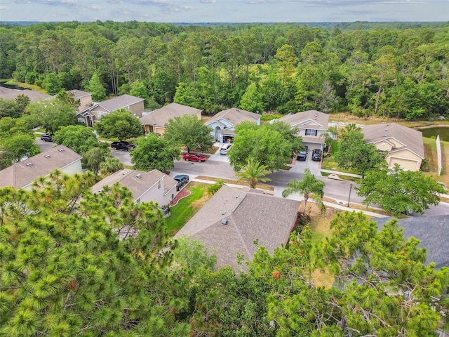 birds eye view of property with a residential view and a view of trees