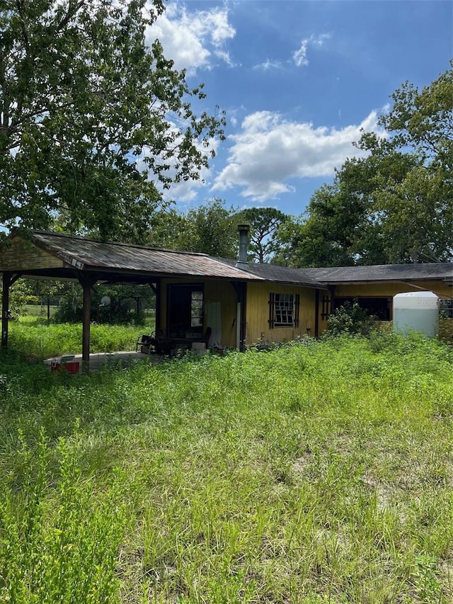 rear view of property with a yard