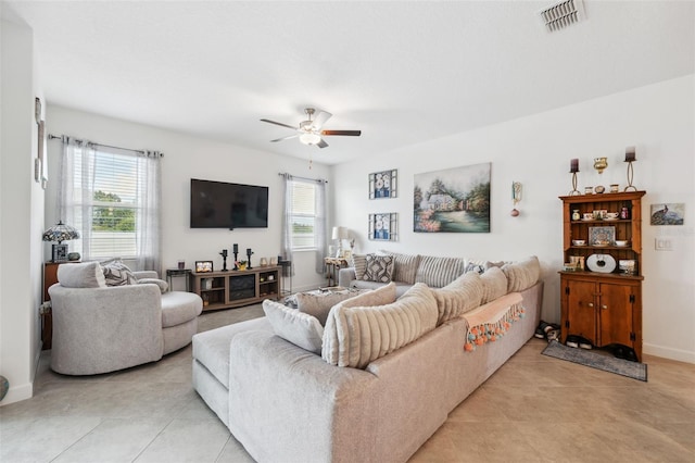 living room featuring light tile patterned floors and ceiling fan