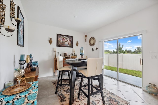 dining space featuring light tile patterned flooring