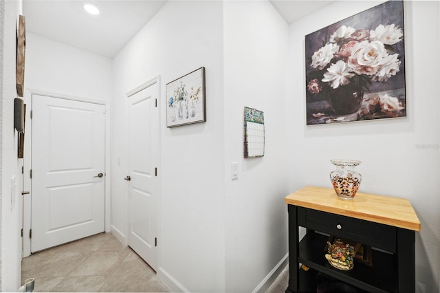 hall with light tile patterned flooring