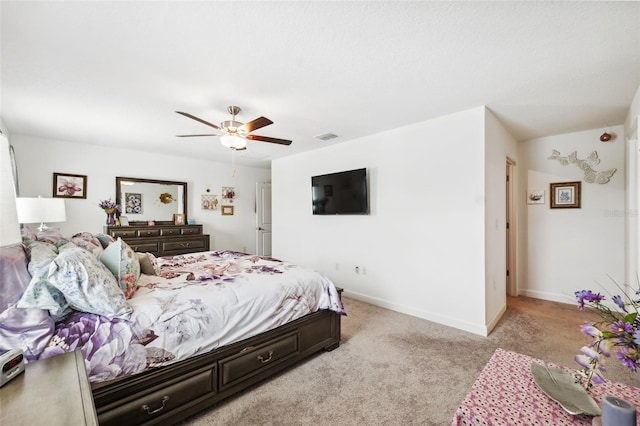 bedroom featuring ceiling fan and light carpet