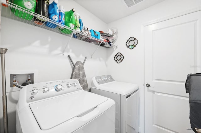 laundry room with separate washer and dryer