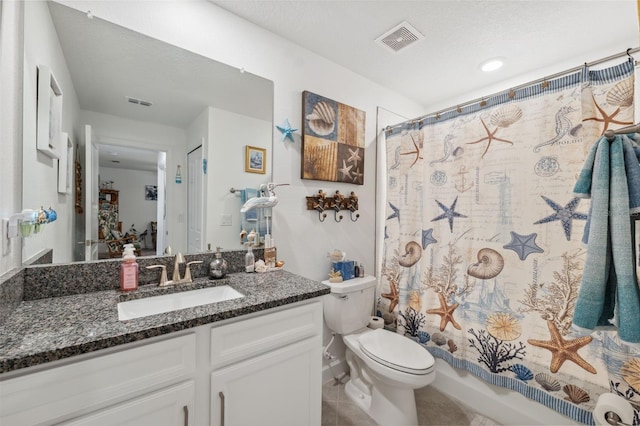 full bathroom featuring tile patterned floors, toilet, shower / bath combination with curtain, vanity, and a textured ceiling