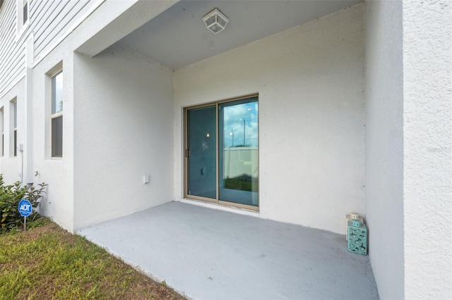 entrance to property with a patio