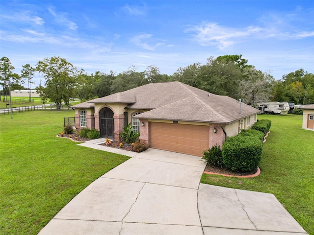 view of front of house with a garage and a front yard