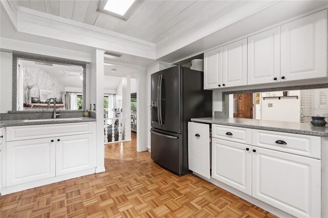 kitchen with white cabinets, sink, stainless steel fridge with ice dispenser, ceiling fan, and light parquet floors