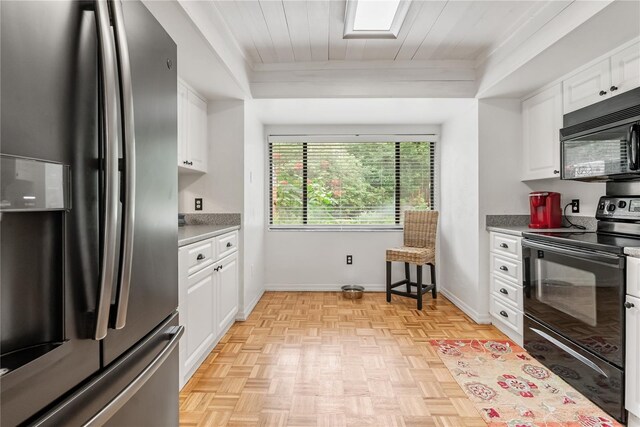 kitchen with black appliances, wooden ceiling, white cabinetry, and light parquet flooring