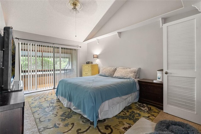 carpeted bedroom featuring lofted ceiling, ceiling fan, access to exterior, and a textured ceiling