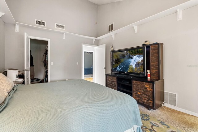 bedroom featuring light carpet and a closet