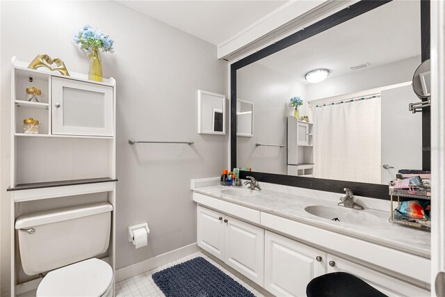 bathroom featuring vanity, toilet, and tile patterned floors