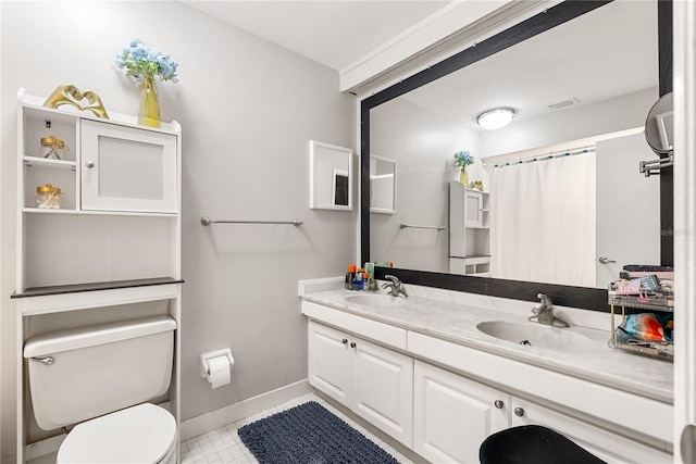 full bathroom with double vanity, toilet, baseboards, and a sink