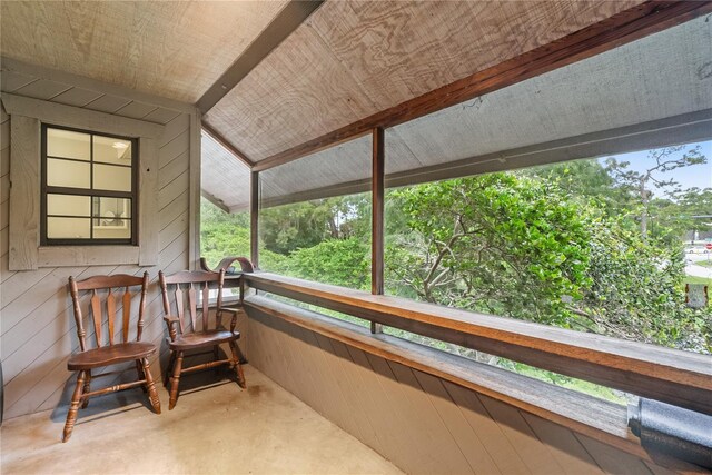 sunroom featuring vaulted ceiling