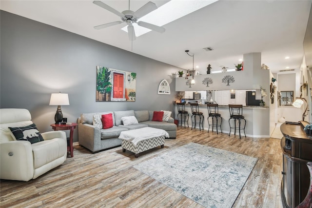 living room featuring hardwood / wood-style floors and ceiling fan