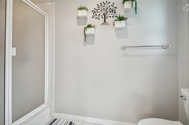 bathroom featuring walk in shower and toilet