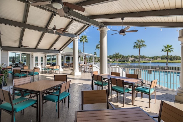 view of patio featuring a water view, outdoor dining space, and a ceiling fan