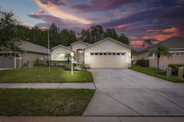 single story home featuring stucco siding, driveway, an attached garage, and a front yard