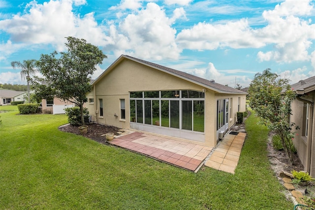 back of house with a yard, a patio area, cooling unit, and stucco siding