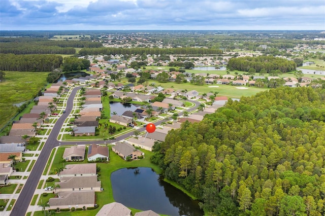 drone / aerial view featuring a residential view and a water view