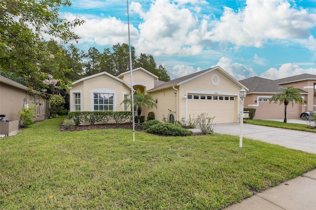 ranch-style house featuring stucco siding, a front yard, a garage, and driveway