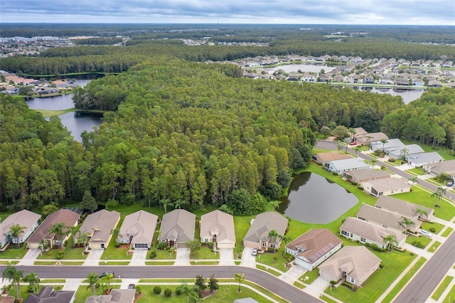 aerial view with a residential view, a wooded view, and a water view