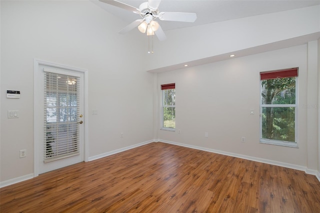 spare room with ceiling fan, baseboards, and wood finished floors