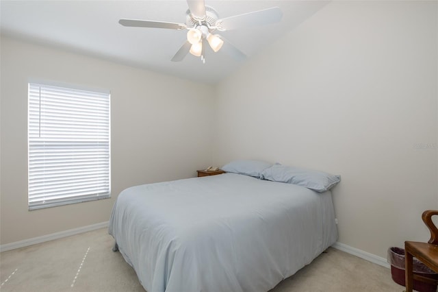 bedroom featuring vaulted ceiling, light colored carpet, baseboards, and ceiling fan