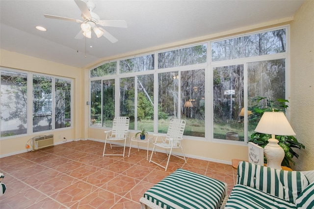 unfurnished sunroom featuring lofted ceiling, a wall mounted AC, and ceiling fan